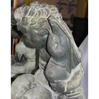 Pair of bronze putti on marble plinths