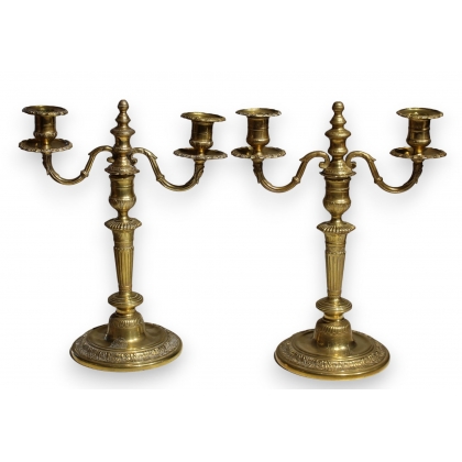 Pair of bronze candlesticks featuring a coat of arms