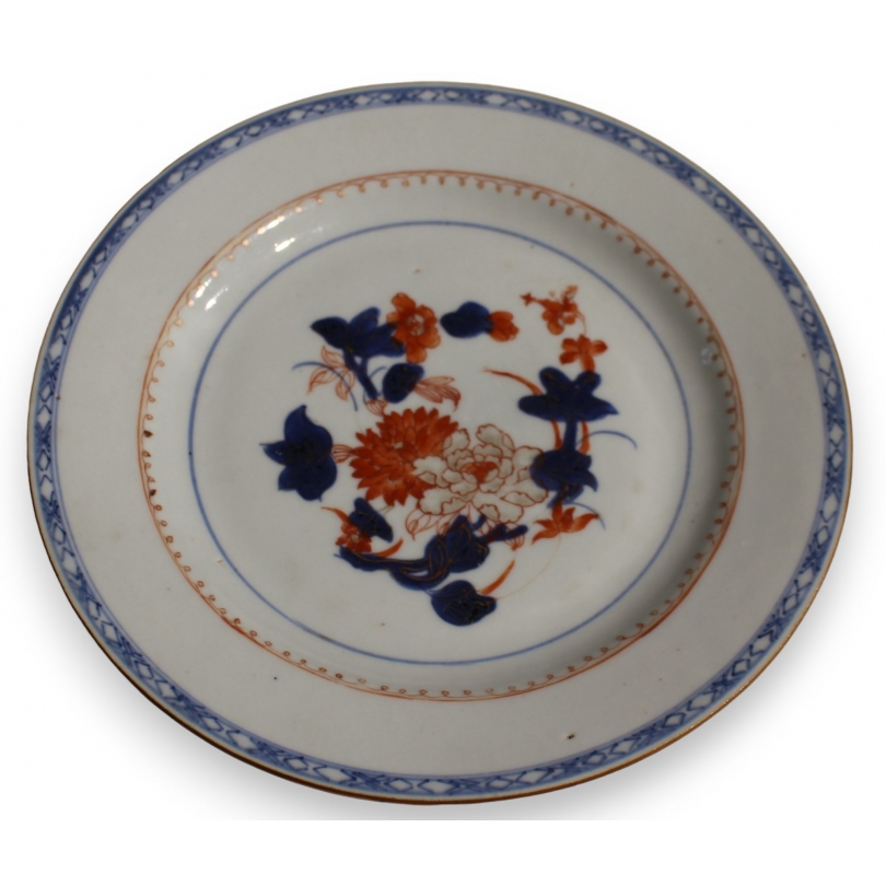 Assiette en porcelaine décor fleurs bleu et orange