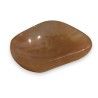 An elongated bowl carved from pale pink hardstone