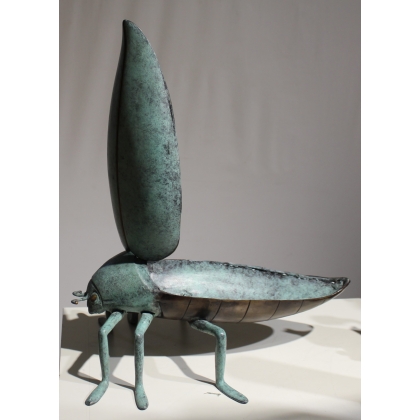 Bronze beetle with a green patina, shaped like a box