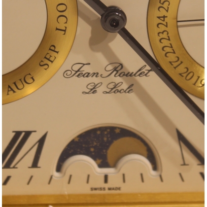 Rounded clock in gilded brass by Jean ROULET