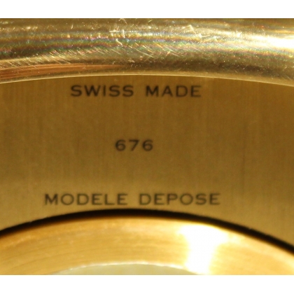 Rounded clock in gilded brass by Jean ROULET