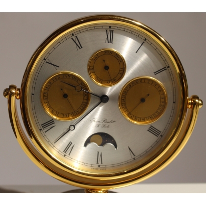 Circular clock in gilded brass by Jean ROULET