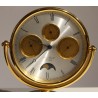 Circular clock in gilded brass by Jean ROULET
