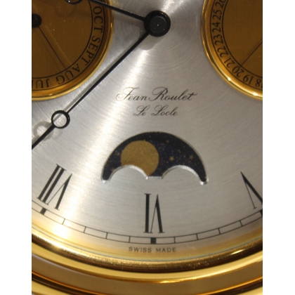 Circular clock in gilded brass by Jean ROULET