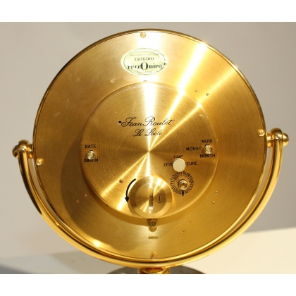Circular clock in gilded brass by Jean ROULET