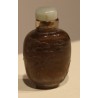 Brown glass snuff bottle with an engraved ‘Dogs’ design