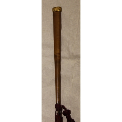 Red silk parasol with a wooden handle and a pompom