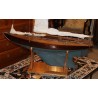 Model of a blue-hulled sailing boat