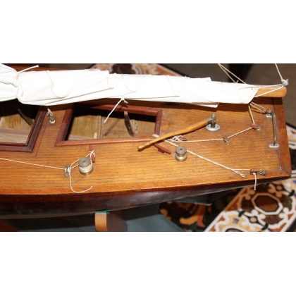 Model of a blue-hulled sailing boat