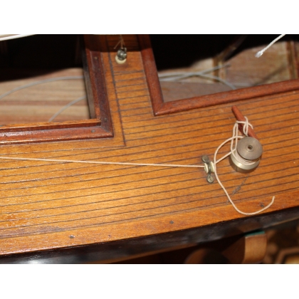 Model of a blue-hulled sailing boat