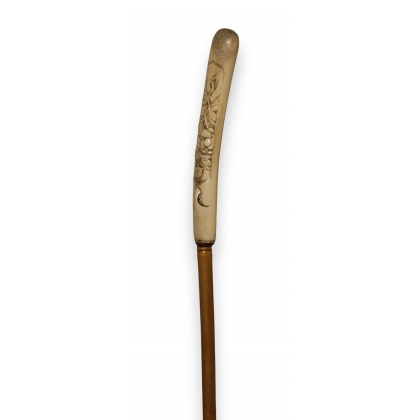 Bone-handled walking stick with a flower-adorned shaft