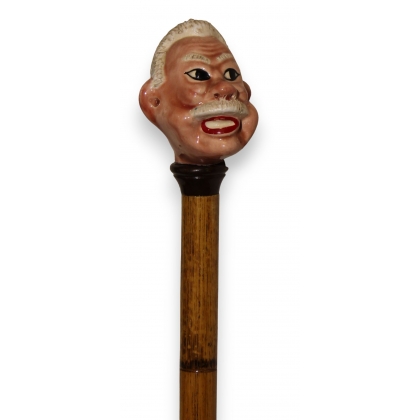 Porcelain walking stick with a moustachioed man’s head