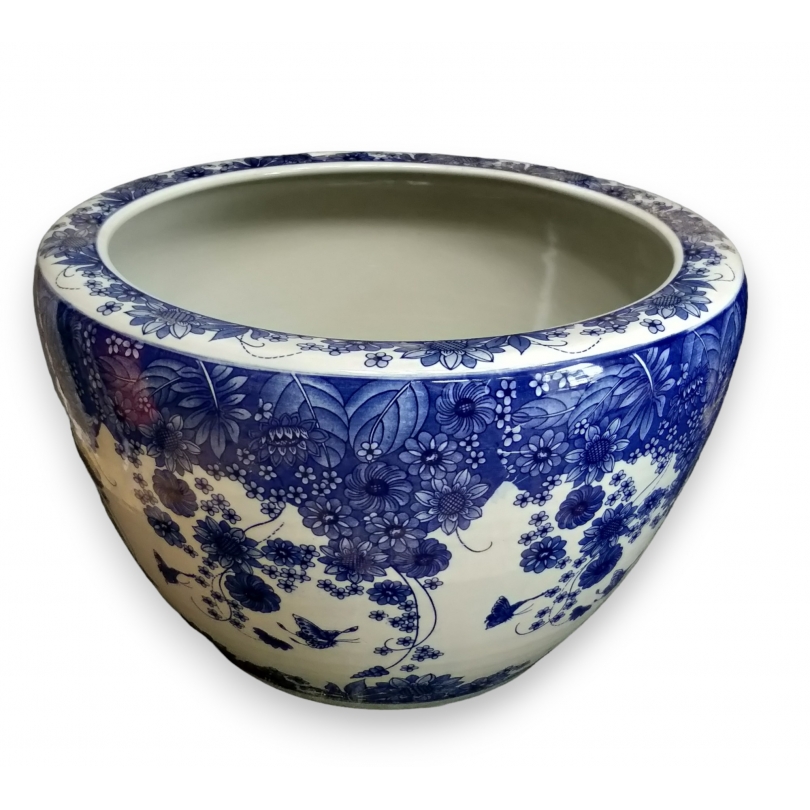 Blue and white plant pot with a butterfly design