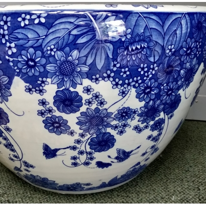 Blue and white plant pot with a butterfly design