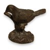 Bronze bird on a branch