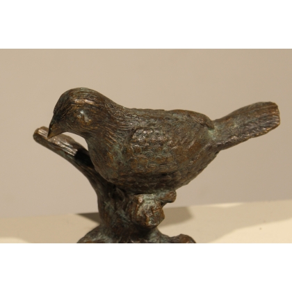Bronze bird on a branch