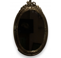 Miroir ovale décor noeud en laiton