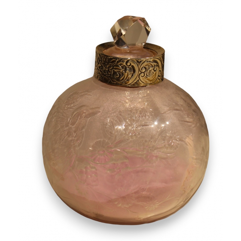 A clear crystal bottle decorated with flowers