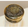 Toiletries bottle with a vermeil-plated cap