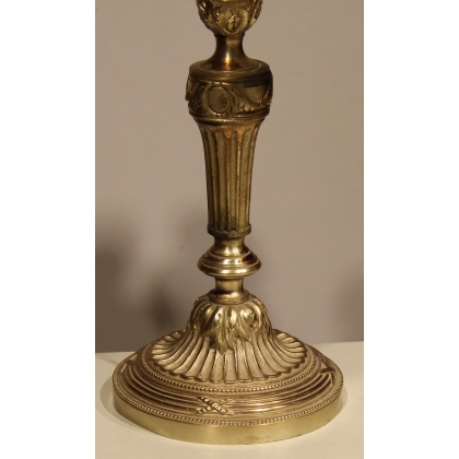 A pair of Louis XVI candlesticks in silver-plated bronze
