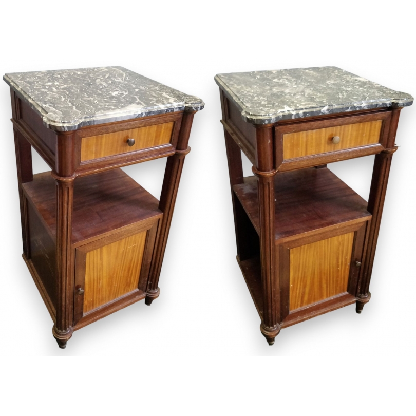 A pair of Louis XVI-style bedside tables with marble tops