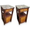 A pair of Louis XVI-style bedside tables with marble tops