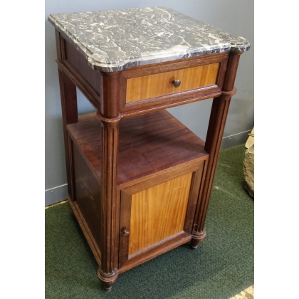 A pair of Louis XVI-style bedside tables with marble tops