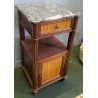 A pair of Louis XVI-style bedside tables with marble tops
