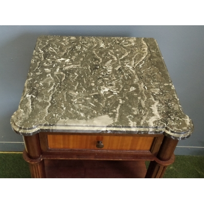 A pair of Louis XVI-style bedside tables with marble tops