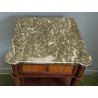 A pair of Louis XVI-style bedside tables with marble tops