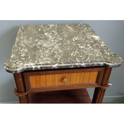 A pair of Louis XVI-style bedside tables with marble tops