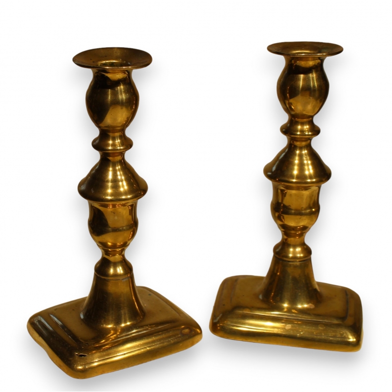 A pair of brass candlesticks by John Turner & Co