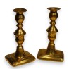 A pair of brass candlesticks by John Turner & Co