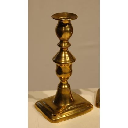A pair of brass candlesticks by John Turner & Co
