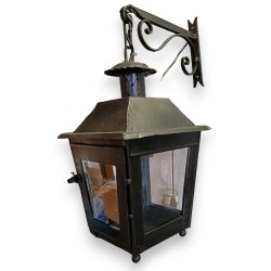 Lantern with a black wrought-iron bracket
