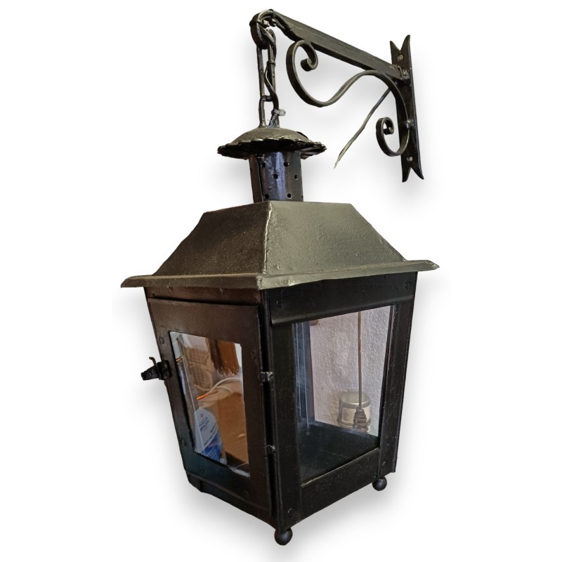 Lantern with a black wrought-iron bracket