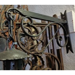 Lantern with a black wrought-iron bracket