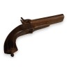 Percussion pistol with a retractable trigger