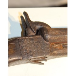 Percussion pistol with a retractable trigger