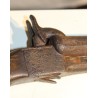 Percussion pistol with a retractable trigger