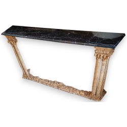 Carved wooden console table with a gilded finish and a black marble top