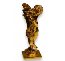Bronze doré "Cupidon versant sur un coeur"