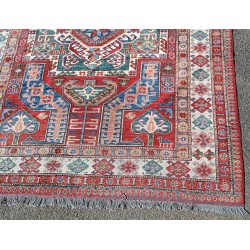 Kazak carpet with a red background