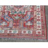 Kazak carpet with a red background