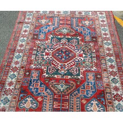 Kazak carpet with a red background