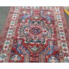 Kazak carpet with a red background