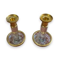 A pair of glass and gilded brass candlesticks
