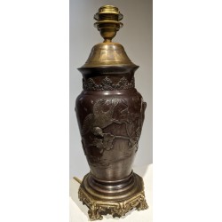 Bronze lamp with a relief design of birds
